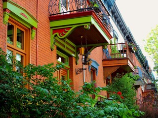 Entrance porches of colored houses in Montreal, Plateau Mont Royal neighborhood during housing crisis of 2021 with homes and apartment prices reducing mortgage possibilities in gentrification area