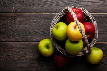 Fototapeta na wymiar Colorful ripe apple fruits in basket