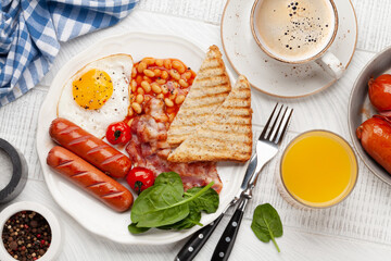 English breakfast with fried eggs, beans, bacon and sausages