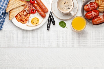 English breakfast with fried eggs, beans, bacon and sausages
