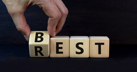 Best rest symbol. Businessman turns wooden cubes and changes the word Rest to Best. Beautiful grey table grey background. Business and best rest concept. Copy space.