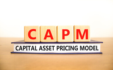 CAPM capital asset pricing model symbol. Concept words CAPM capital asset pricing model on cubes on a beautiful white background. Business CAPM capital asset pricing model concept. Copy space.