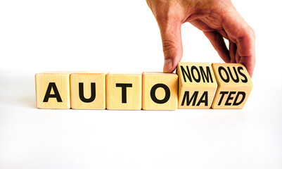 Autonomous or automated vehicle symbol. Businessman turns cubes and changes words Autonomous to Automated. White background. Business technology autonomous or automated vehicle concept. Copy space.