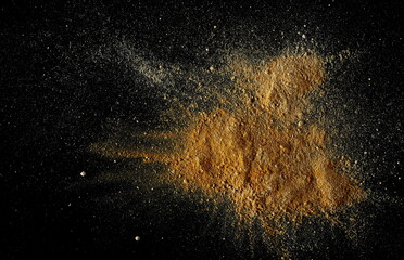 Mixed ginger and turmeric (Curcuma) powder pile isolated on black, top view
