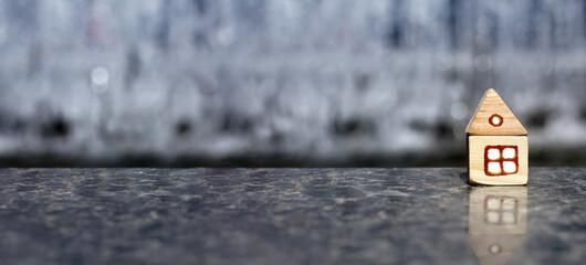 one-story wooden house with a window and a roof on a granite base. combination of different materials in construction