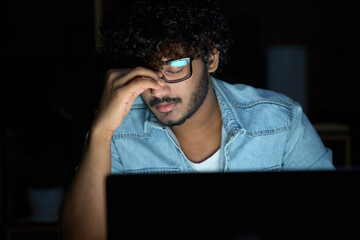 Tired sleepy stressed overworked young indian business man student wearing glasses feeling lack of...