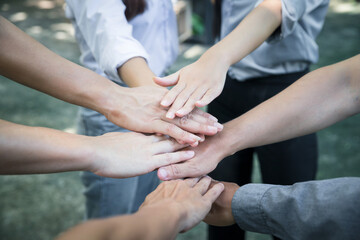 Top view of group of people team showing unity with putting their hands together in circle. Diversity hands join together for support and teamwork. Concept of teamwork.
