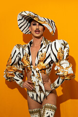 beautiful drag queen model with yellow background.