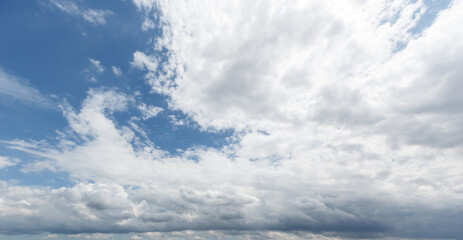blue sky background with white clouds cumulus floating soft focus, copy space.