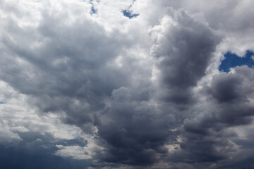 The dark sky had clouds gathered to the right and a strong storm before it rained. Bad weather sky.
