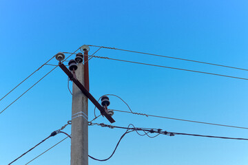 Electric concrete pole against a clear blue sky