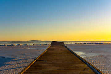 pontoon on the frozen lake at sunrise