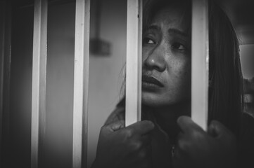 Fototapeta na wymiar Hands of women desperate to catch the iron prison,prisoner concept,thailand people,Hope to be free,If the violate the law would be arrested and jailed.