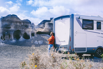 Vacation and travel lifestyle people and scenic destination place. Man standing against big camper...