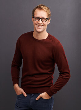 A great autumn look. A studio portrait of a handsome man wearing glasses.