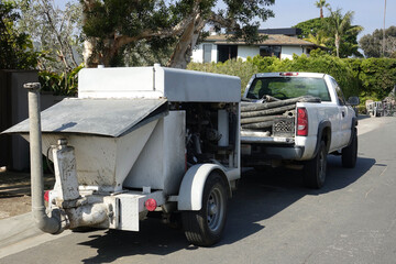 concrete pumper towed by a pick up truck