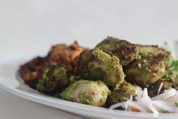 Green and red chicken kababs. Boneless chicken cubes marinated and air fried
