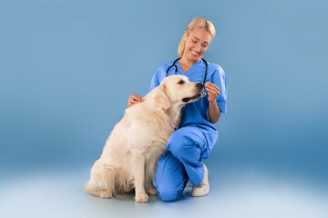 Nurse In Scrubs Uniform Posing With Dog Giving Food