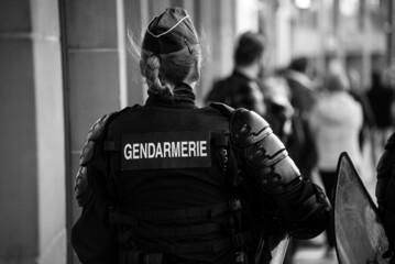 Strasbourg - France - 19 March 2022 - Portrait on back view of french gendarmerie riot policewoman walking in the street - 493819674