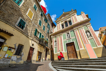 Old houses and catholic church in small town of Dolceacqua, Italy. - obrazy, fototapety, plakaty