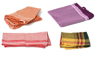 folded kitchen textile towels of different colors on a white background, set