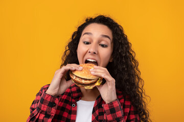 Funny Latin Lady Holding Burger Biting Sandwich At Studio