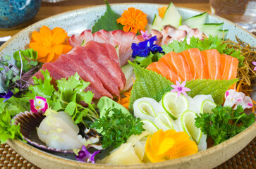 Platter decorated with different flavors of elegant sushi.