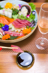 Obraz na płótnie Canvas Woman eating delicious sashimi, closeup on chopsticks.