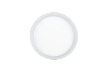 Milk in bowl on isolated white background, top view