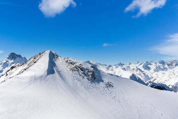 Panorama of winter snowy mountains in Caucasus region, Russia