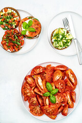 Healthy fresh salad with tomatoes and basil, sandwich with tomatoes,cucumber,feta,mozzarella and herbs. Healthy food concept.