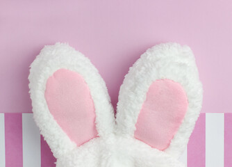 Bunny ears for Easter on pink background with copyspace