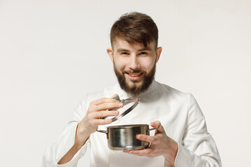 kind and handsome cook holds kitchen utensils on a white isolated background. concept for a cook