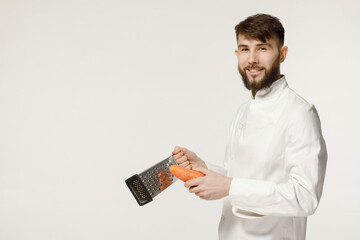 kind and handsome cook holds kitchen utensils on a white isolated background. concept for a cook