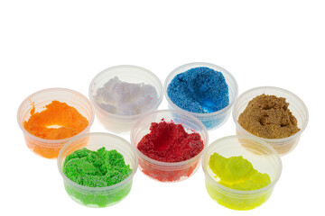 Close up view of colorful play dough materials isolated on white background. 