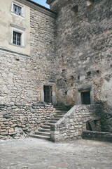 Fototapeta na wymiar Yard and stairs in an ancient castle. Old castle in Ukraine