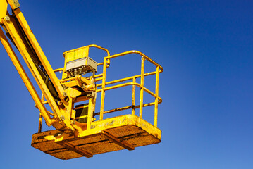 Basket lift, lifting platform on construction site.