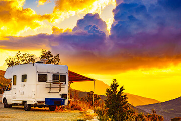 Rv camper in mountains at sunset, France.