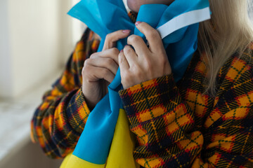 refugee woman with flag of ukraine