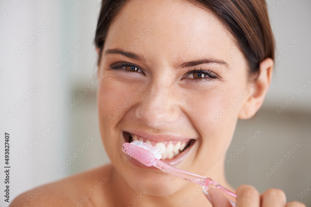 Canvas Prints Shes all about dental hygiene. A gorgeous young brunette brushing her teeth in the morning.