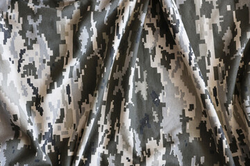 Fabric with texture of Ukrainian military pixeled camouflage. Cloth with camo pattern in grey,...