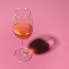 Glass of Rosé Wine on Pink Background