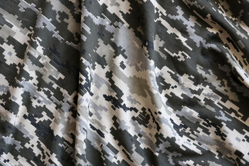 Fabric with texture of Ukrainian military pixeled camouflage. Cloth with camo pattern in grey,...