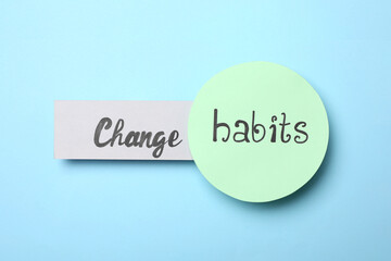 Flat lay composition with phrase Change Habits on light blue background