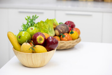 delicious ripe fruits in wooden bowl on a table