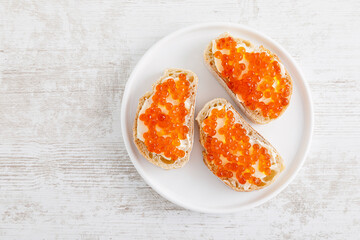 Open sandwiches with red salmon caviar. Top view, flat lay