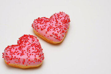 Naklejka na ściany i meble pink donuts hearts on a white background close-up