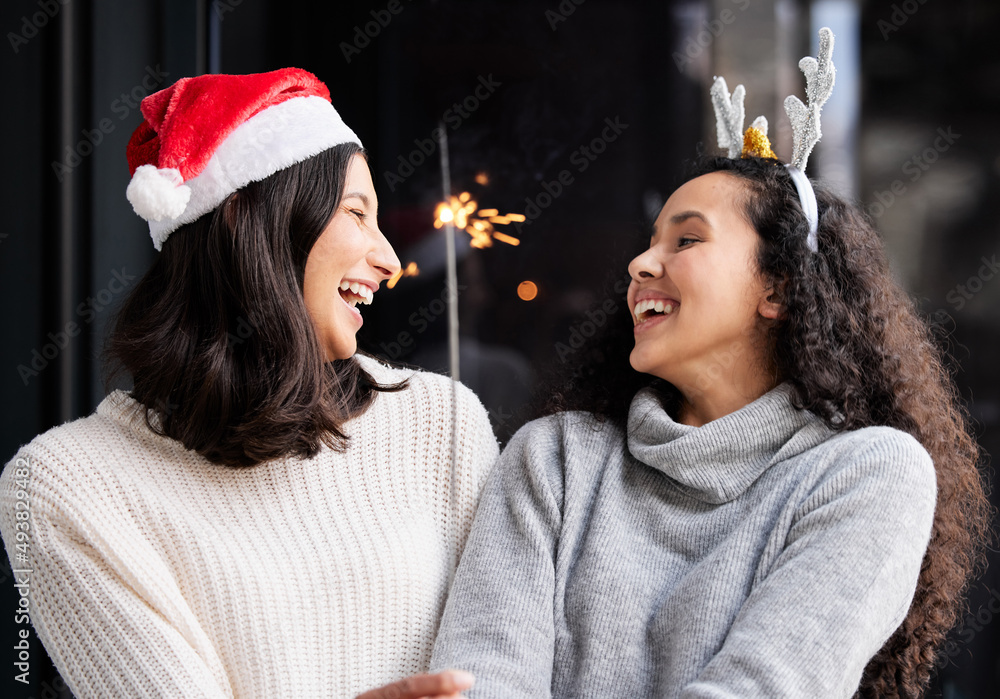 Canvas Prints I will honor Christmas in my heart, and try to keep it all the year. Shot of two friends using a sparkle stick ay home.