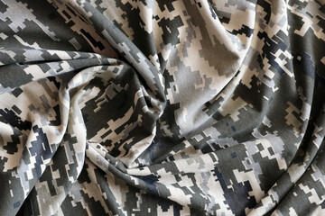 Fabric with texture of Ukrainian military pixeled camouflage. Cloth with camo pattern in grey,...