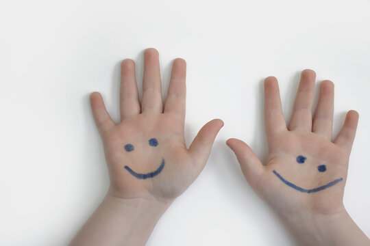 hand of a child with a painted smile on a white background - Powered by Adobe